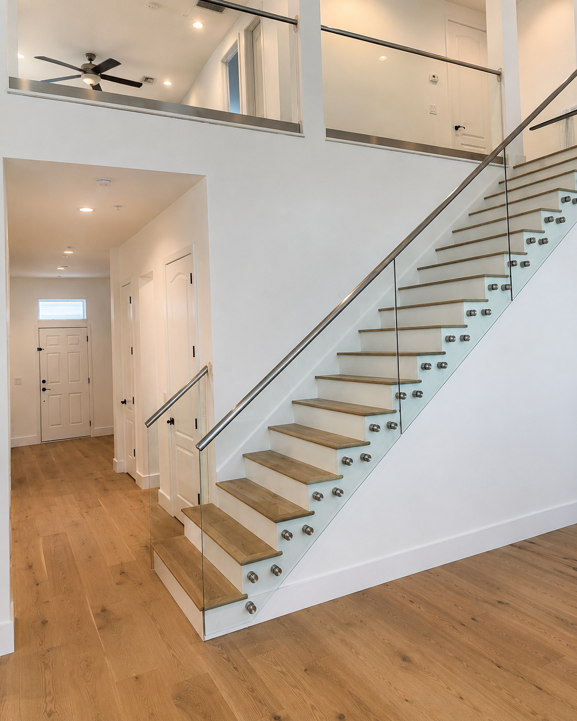 Before view of the Winter Park staircase and entry wall before the black geometric accent wall was installed.